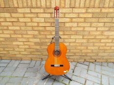 A Yamaha classical guitar, model number CG100A, with soft case, pitch pipe,