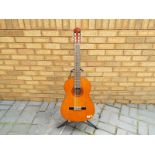 A Yamaha classical guitar, model number CG100A, with soft case, pitch pipe,