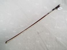 A good quality violin bow with silver mounts, ebony block with mother of pearl inlays,