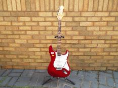 An Encore stratocaster style electric guitar,