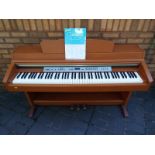 A Yamaha Clavinova CLP-230 piano with manual