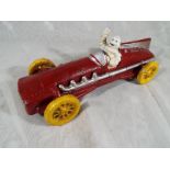 A cast iron novelty red racing car in the form of a 1934 Hubley marked Michelin with a depiction of