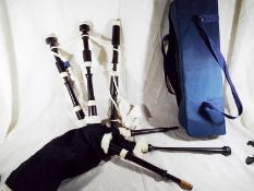 A set of Bagpipes by Piob Mhor of Scotland, African hardwood, Canmore bag, cords, Ross drone reeds,