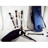 A set of Bagpipes by Piob Mhor of Scotland, African hardwood, Canmore bag, cords, Ross drone reeds,