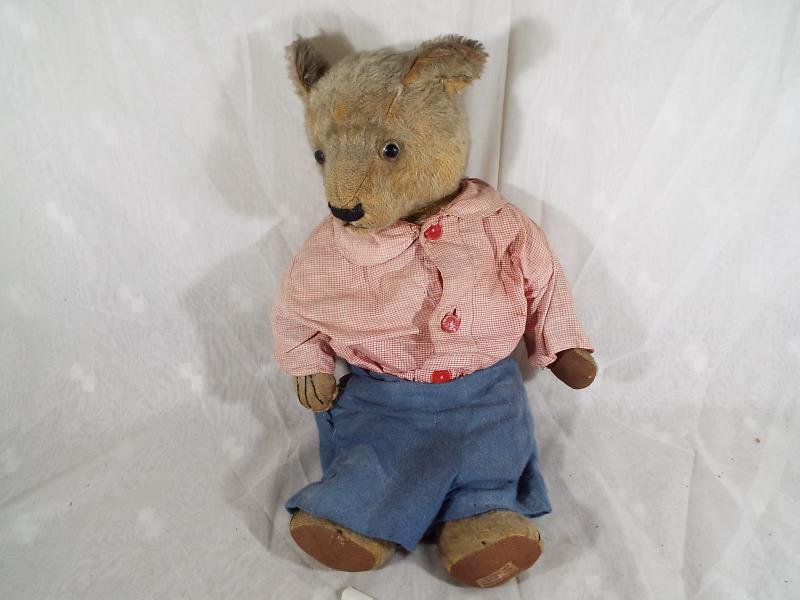 A vintage Bear by Chad Valley, glass eyes, stitched nose, mouth and claws,
