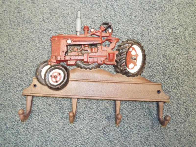 A cast iron wall mounted novelty coat hangar with tractor decoration - Est £20 - £30
