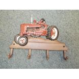 A cast iron wall mounted novelty coat hangar with tractor decoration - Est £20 - £30