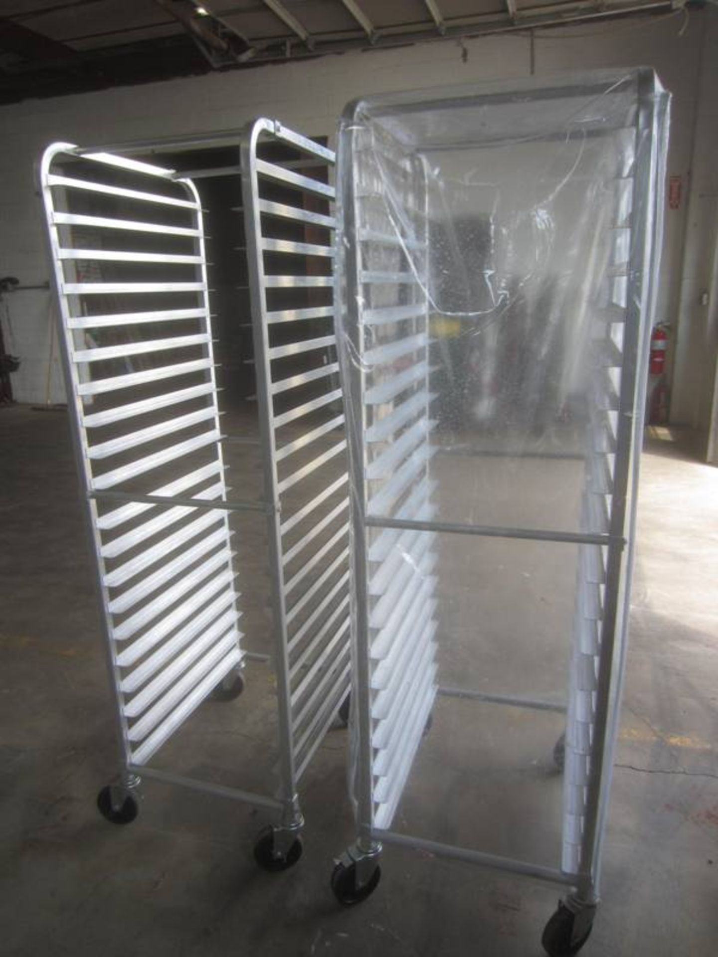 Aluminum Rack, 8" W X 26" L X 70" T, 20 shelves spaced 3" apart, on wheels, plastic covers - Image 2 of 2