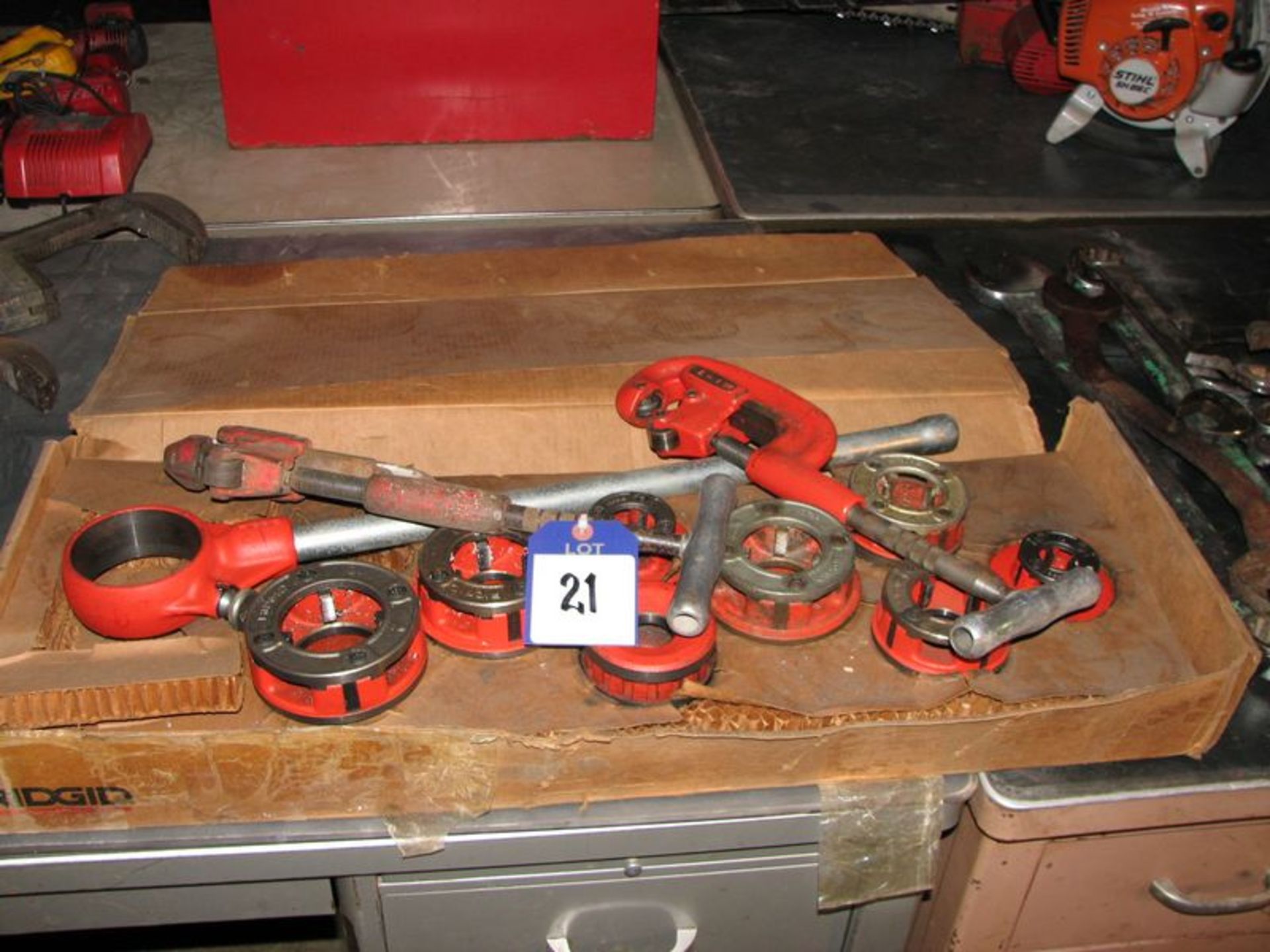 Lot includes Ridgid pipe threader and (2) pipe cutters