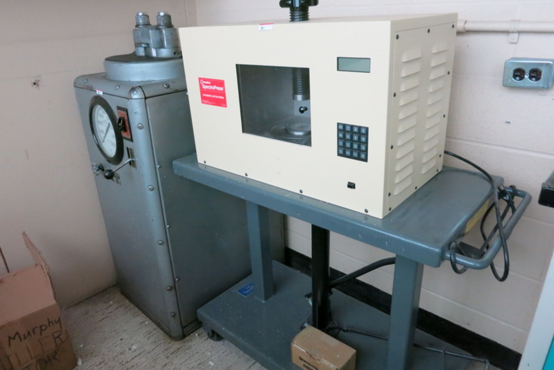 Chemplex spectropress, model 4350, s/n 01206011, mounted on mobile hydraulic table