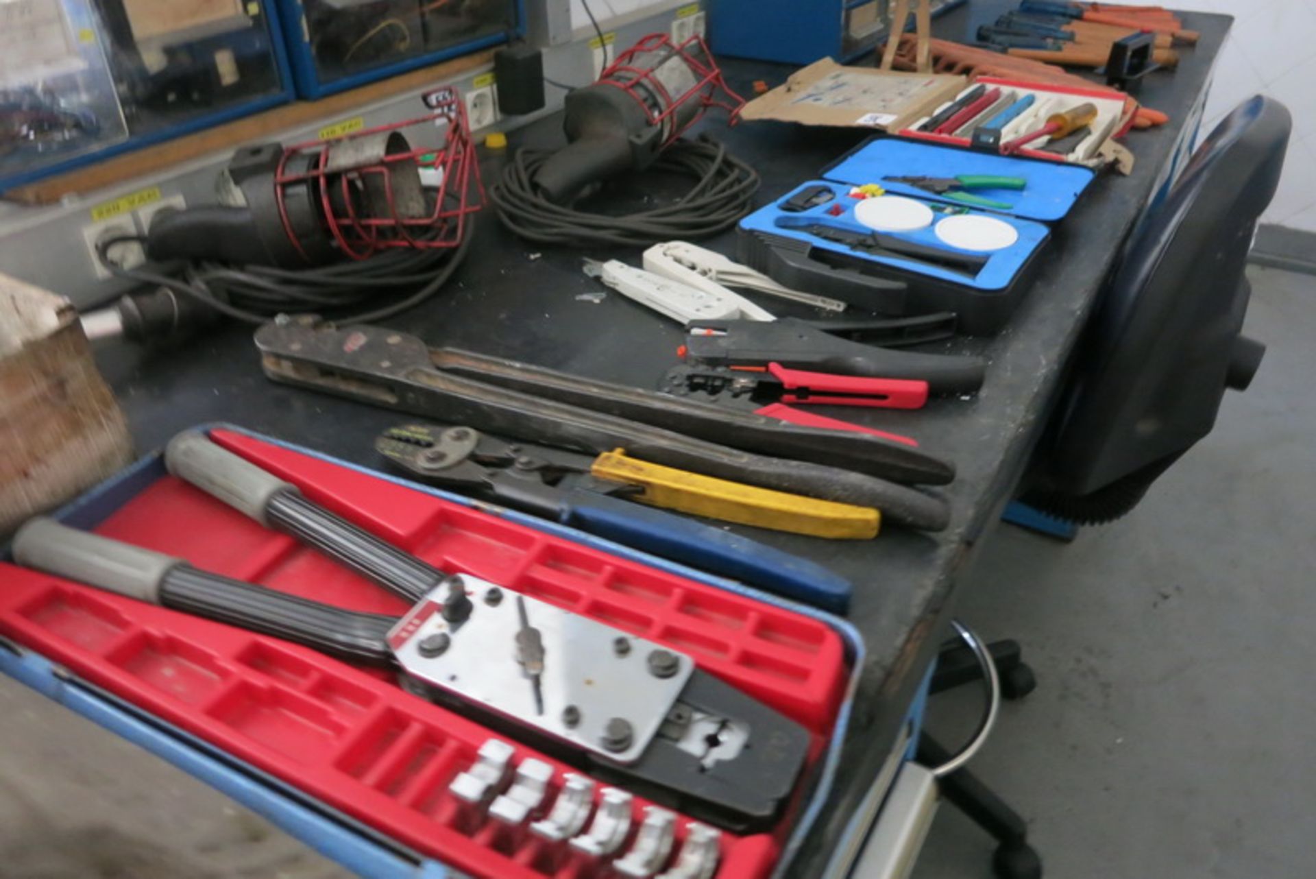 Electrical tools, wire strippers, testers, wrenches (contents on bench)