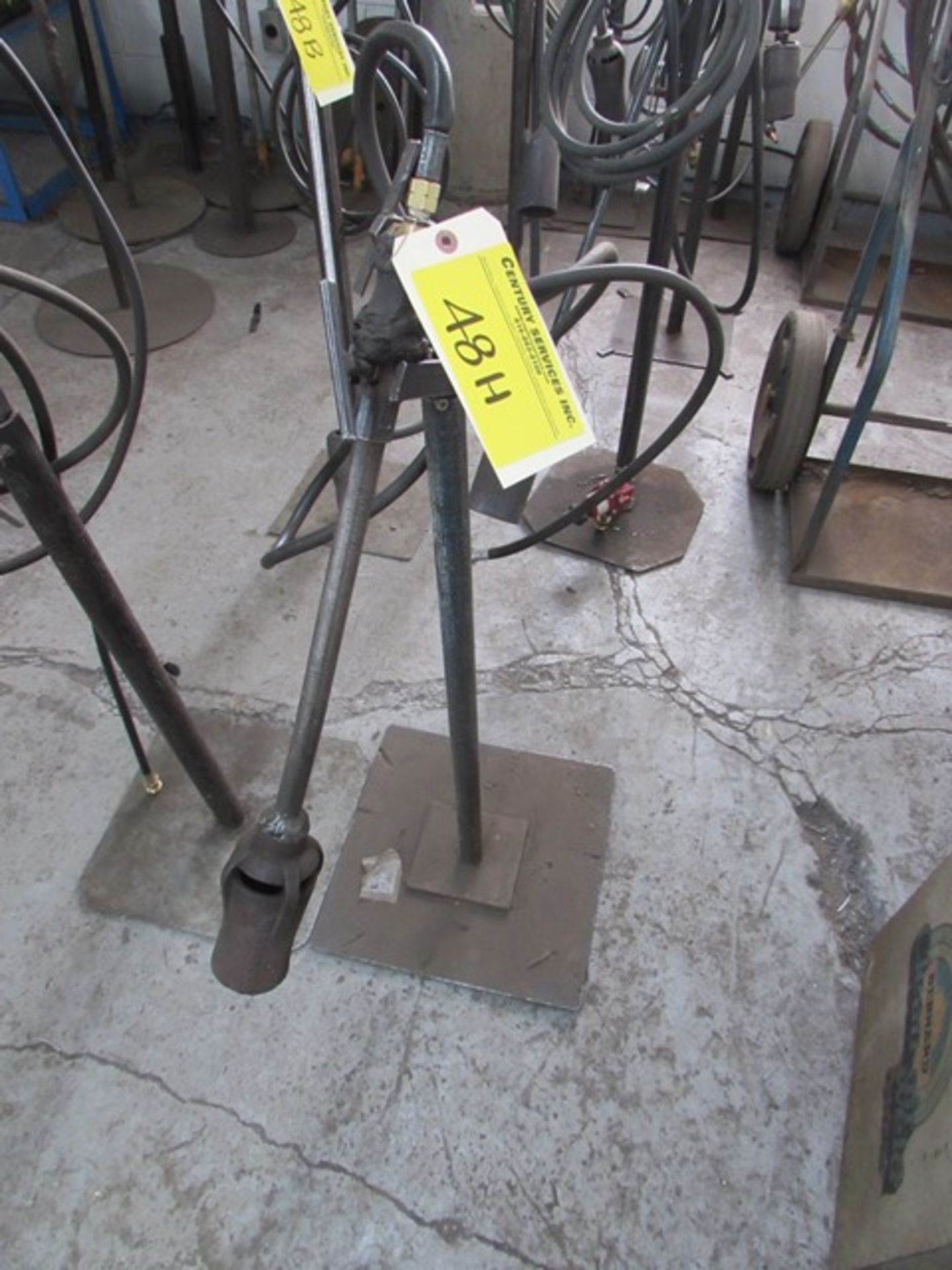 Welding torch on adjustable height stand