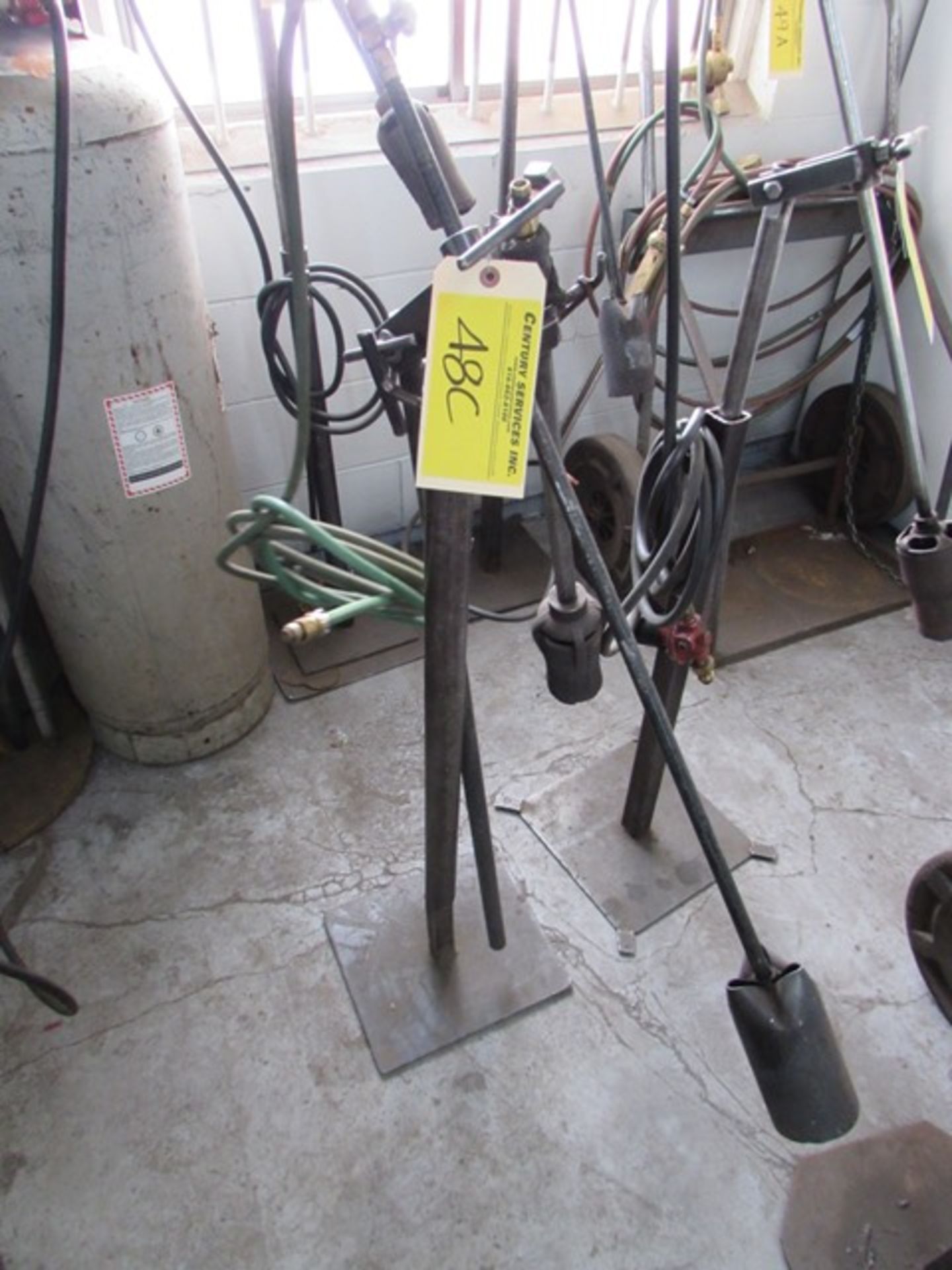 Welding torch on adjustable height stand