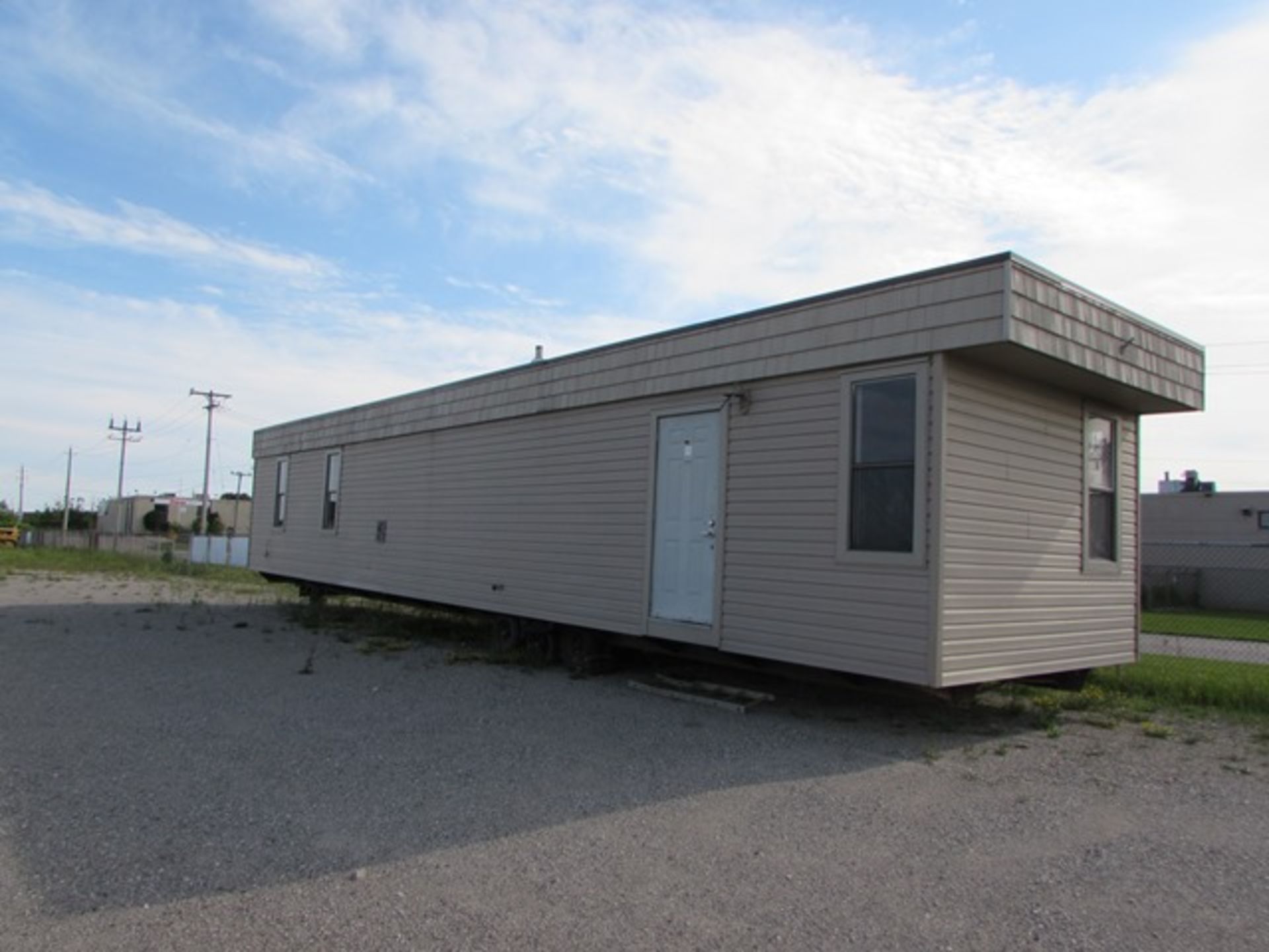 Portable home/trailer c/w French doors, vinyl siding, air conditioned, rough - in for hydro,