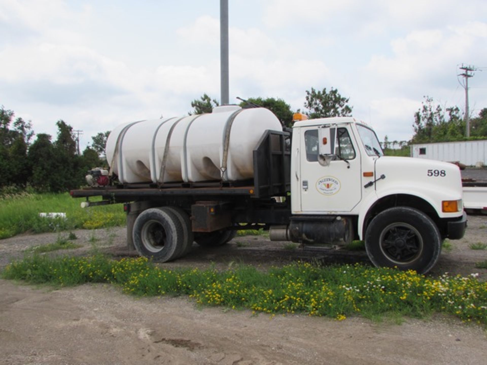 1992 International "4700" flatbed truck c/w 4 X 2 traction, automatic transmission, skid mount water