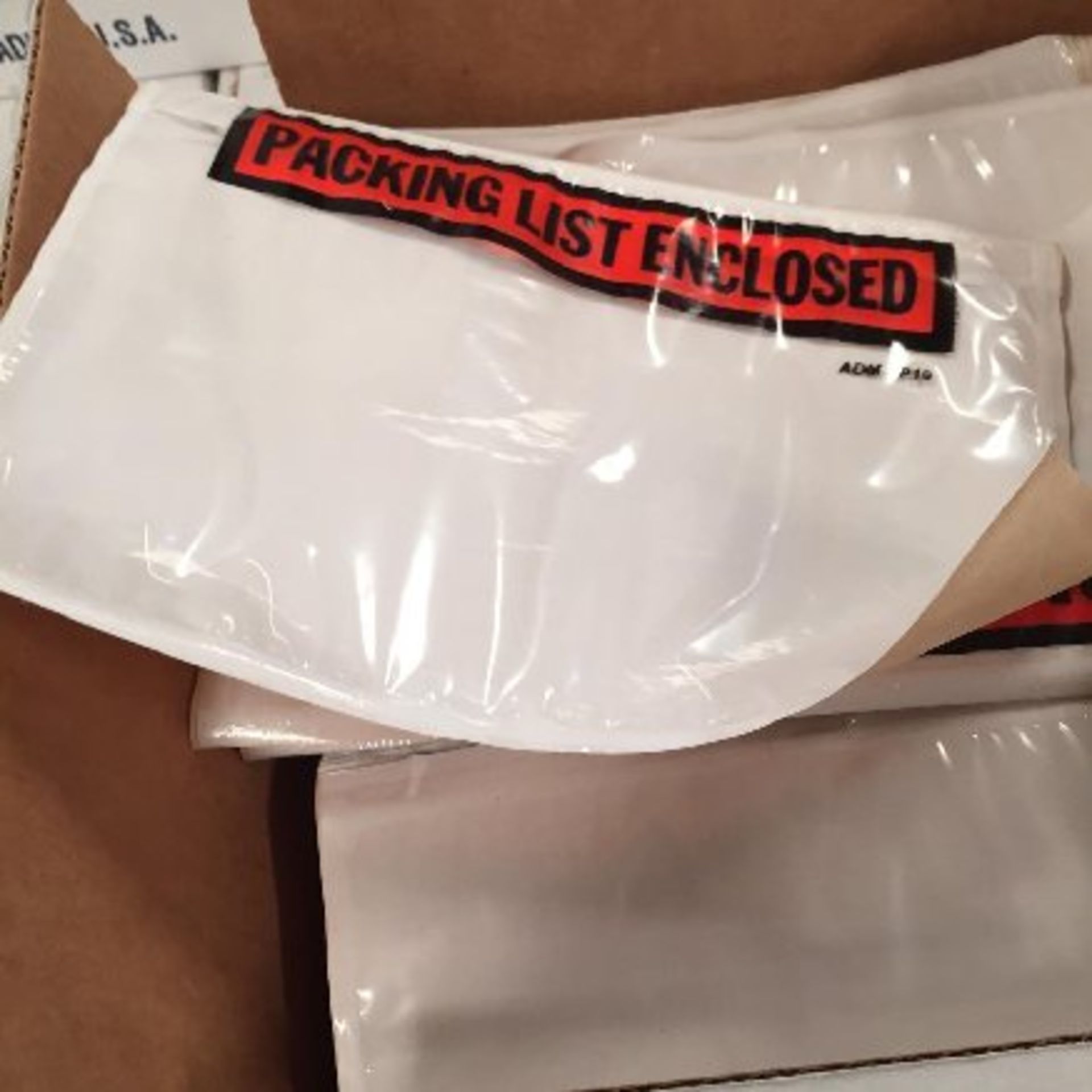 Assorted pressure sensitive packing list envelopes and paper.  Approx. 136,000 packing list