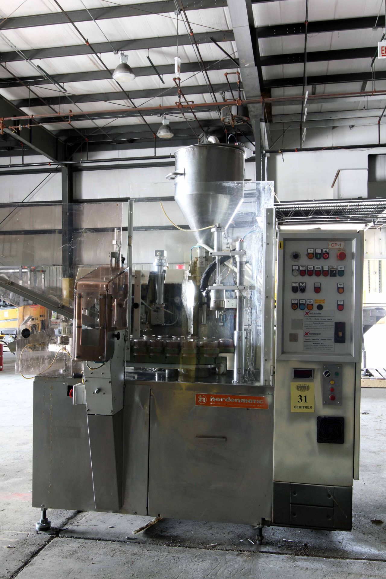 AUTOMATIC ROTARY PLASTIC TUBE FILLER, NORDEN MDL. NM620HA, stainless steel feed hopper, mixed