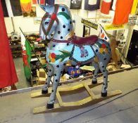 A hand painted wooden rocking horse