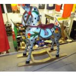 A hand painted wooden rocking horse