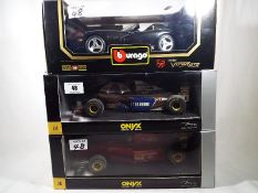 Three diecast model racing cars, 1:18 scale, of which two Onyx and one Burago,