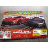 A Micro Scalextric McLaren MP4-12C designed by Jenson Button and Lewis Hamilton boxed set
