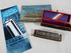 The Super Chromonica chromatic harmonica by Hohner in original case with accompanying manual