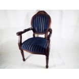 A doll's chair with blue upholstered seat and back,