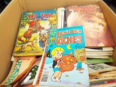 A box of unsorted comics, magazines and