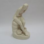 Parian figure of a young girl seated on