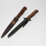 Two old German trench boot knives with wooden handles and steel blades, the longest 29cm including