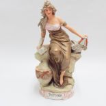 Royal Dux figure - History depicting a female figure seated on a pile of books, applied lozenge