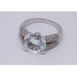 Modern 9ct white gold diamond and blue topaz dress ring, set with a large oval topaz,