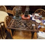 Fretwork wooden trivet and four oil lamps with coloured glass reservoirs