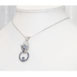 Silver pendant necklace modelled as leopard holding a ring set with sapphires and rubies
