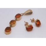 9ct yellow gold and amber drop pendant and a pair of matching ear studs