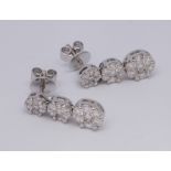 Matching 18ct white gold triple diamond cluster earrings with stud fittings