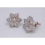 The pair of matching 9ct gold diamond daisy cluster ear studs