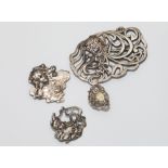 Four items of silver art nouveau design jewellery to include dress ring and 3 brooches