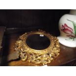 Oval cherub decorated gilt framed wall mirror