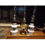 2 decorative china oil lamps and a brass and glass oil lamp