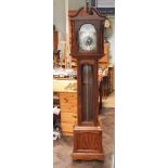 Walnut wood veneered long case clock with arched top and silvered chaptering complete with weights