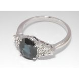 18ct white gold sapphire and diamond cluster ring set with oval sapphire flanked by 6 brilliant cut