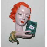 Goldscheider terracotta wall mask of a young red headed female holding a book, original label to the