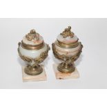 Pair of French onyx covered urns with hinged lids and ormolu decoration of acanthus leaves and