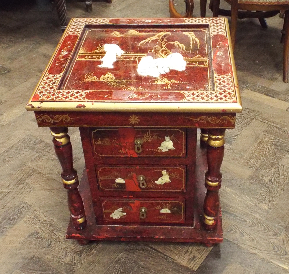 Red lacquered occasional table with fitted drawers below