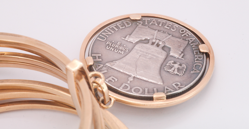 Group of nine 18ct yellow gold bangles and a USA half Dollar charm gross weight 60. - Image 2 of 2