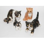 Collection of four Winstanley cats including a seated ginger example,