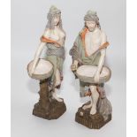 Pair of Austrian porcelain figurines, one of a semi clad classical female figure holding a basket on