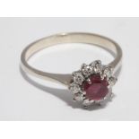 Ruby and diamond circular cluster ring, on unmarked white metal shank, tests as gold,