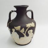 20th century Wedgwood black Jasperware copy of the Portland vase, the base decorated with a cameo of
